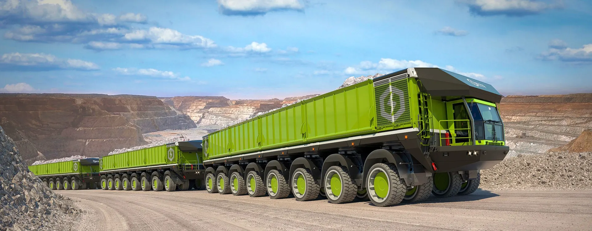 An ETF battery electric haul train carrying ore along a haul road in an open-pit mine